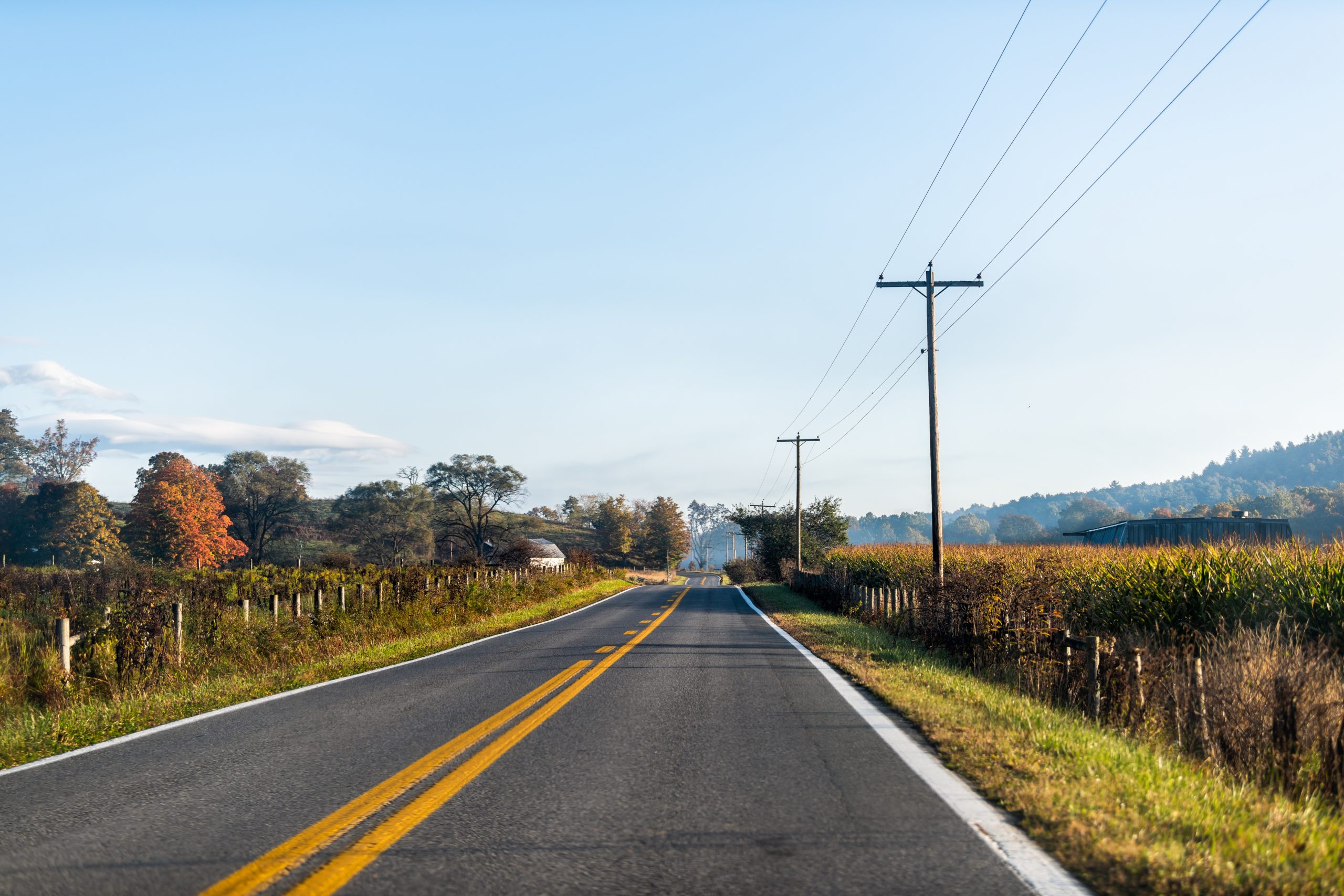 Utility lines run parallel to a two-lane road in rural Virginia, where Starnes Communications provides contracted telecommunications infrastructure through fiber splicing, Network Access points, and line maintenance.